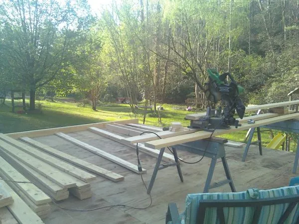 Miter saw and framing lumber on a deck under construction in Poplarville